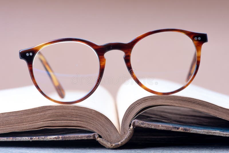 Opened book with reading glasses