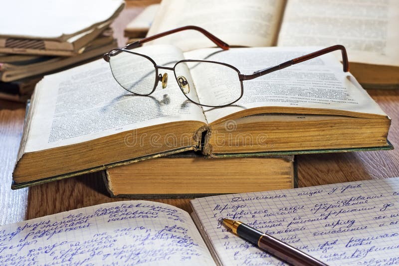 Opened notebook, pen, books and glasses royalty free stock photography Opened notebook, pen, books and glasses royalty free stock photography