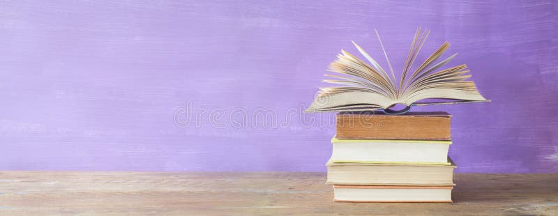 Openend book on purple background. Openend book on purple grungy background, good copy space stock photography