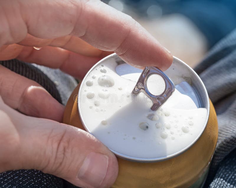 Opening of cold beer can stock image Opening of cold beer can stock image