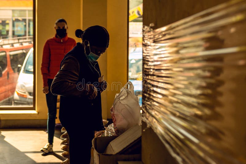 Opening of food markets in Europe during quarantine and the coronavirus pandemic. Black African students buy food during a stock images Opening of food markets in Europe during quarantine and the coronavirus pandemic. Black African students buy food during a stock images