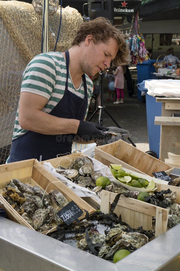 Opening Fresh Oysters at the Market Editorial Photo - Image of