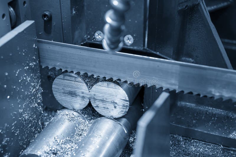 The Operation of Band Saw Machine Cutting the Metal Rod. Stock Photo