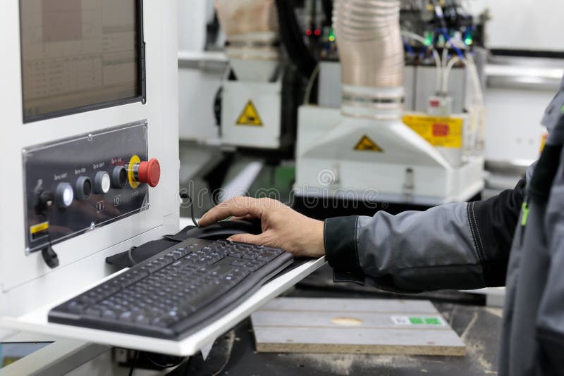 Operator controls computerized woodworking machine. Selective focus. Controls automation stock images, royalty-free photos and pictures