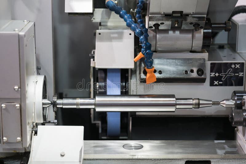 Operator grinding forging die parts stock photos