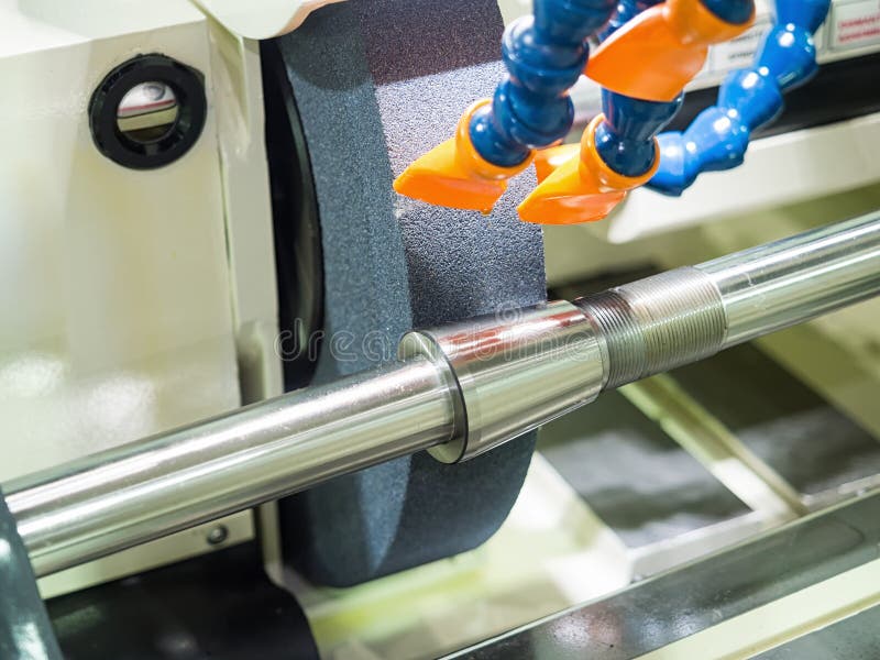 Operator grinding forging die parts stock images
