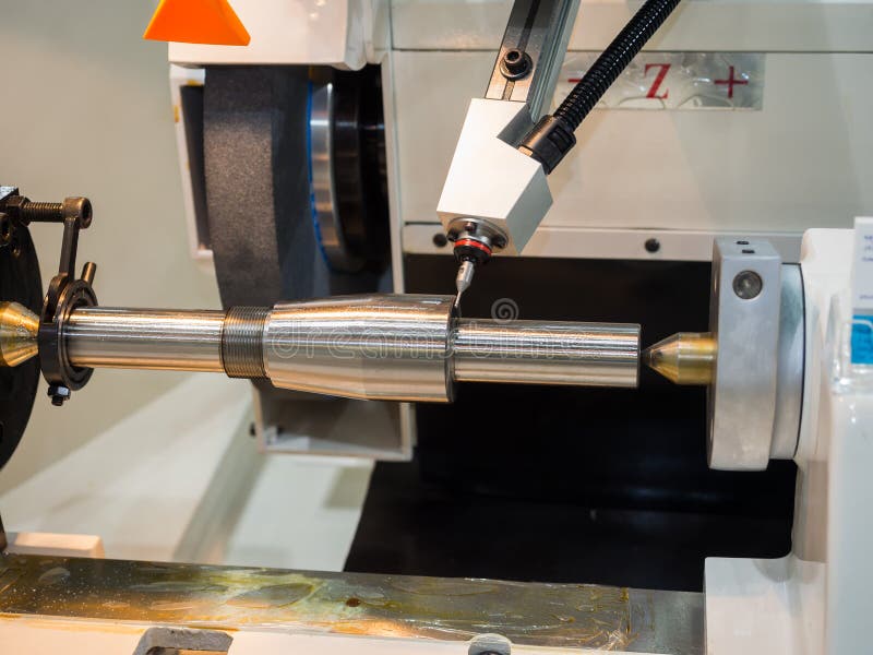 Operator grinding and inspection high precision automotive part royalty free stock photo