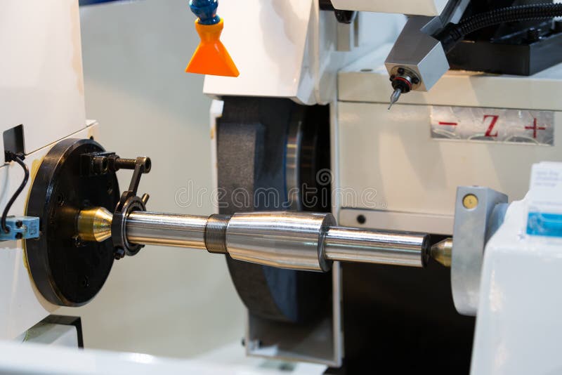 Operator grinding and inspection high precision automotive part stock photo