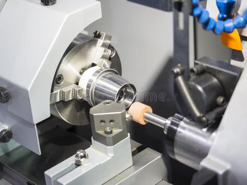 Operator grinding mold and die part stock photography