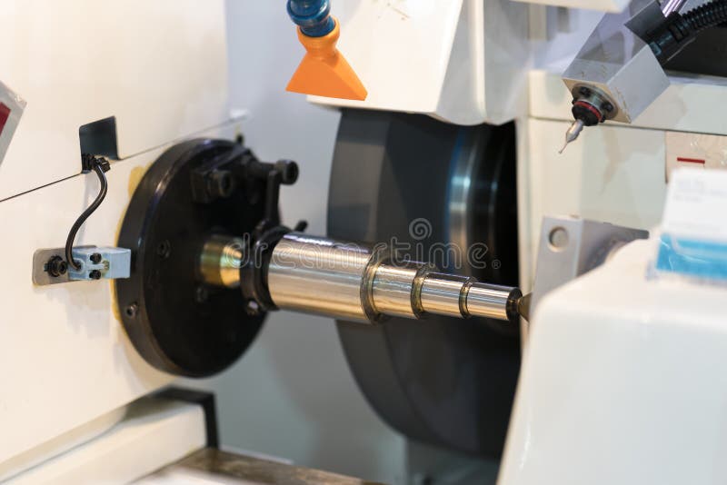 Operator grinding mold and die part by universal grining machine stock photography