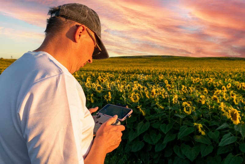 The Operator Holds the Remote Control of the Drone in His Hands. a