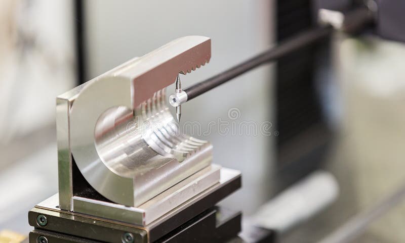 Operator inspection automotive part by contour measuring machine stock photo