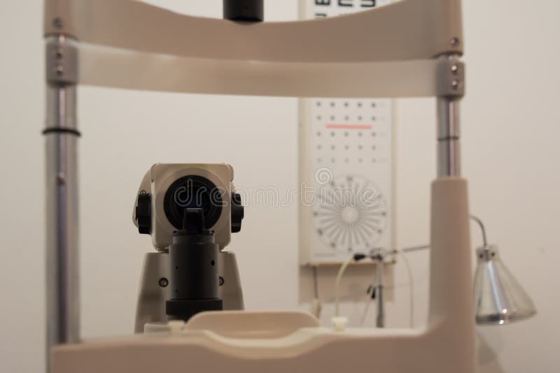 Ophtalmology clinic, slit lamp, patient point of view. Optotype in the back stock photography