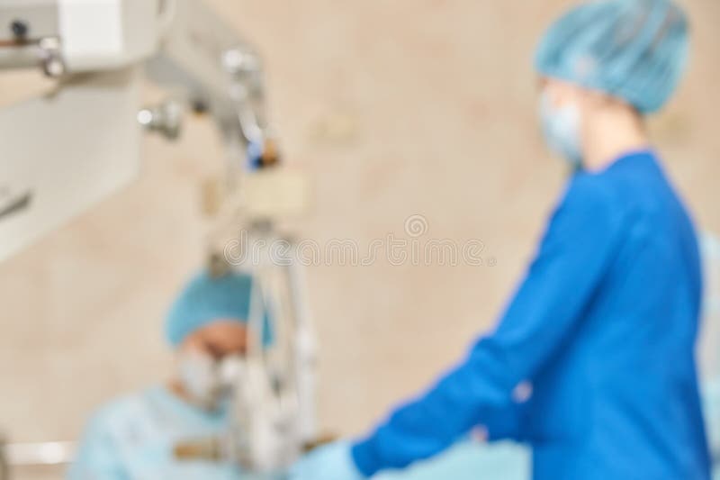 Ophthalmology laser microscope operation. Clinic room with doctor and parient. Blur background. Unfocus, selective focus.