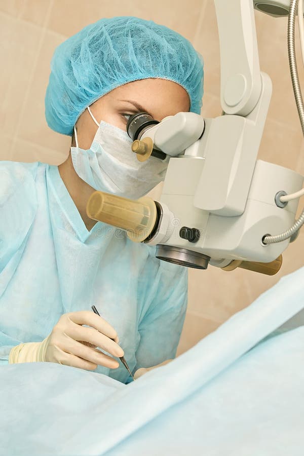 Ophthalmology laser microscope operation. Doctor in clinic. Patient eye treatment. Myopia and cataract removal.