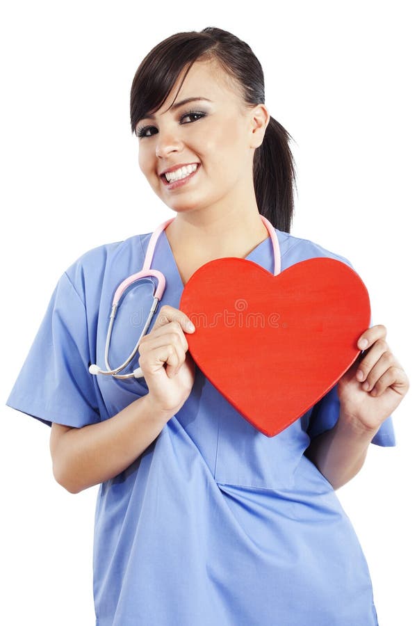 Stock image of female healthcare worker holding heart shape isolated on white background. Stock image of female healthcare worker holding heart shape isolated on white background