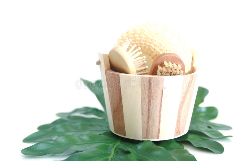 Skin care items in a wooden bucket on a green leaf. Skin care items in a wooden bucket on a green leaf