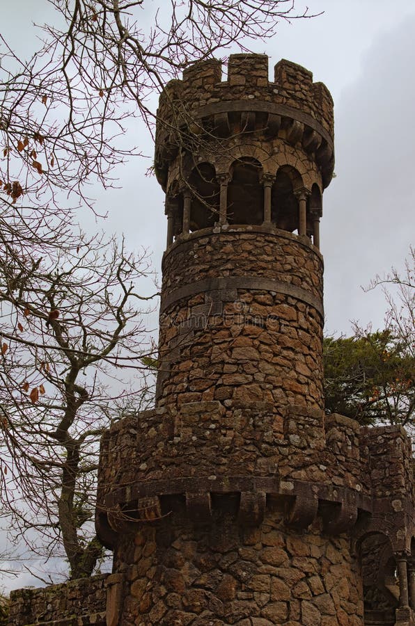 Opinião cênico da manhã da torre de pedra antiga no palácio Quinta da Regaleira de Regaleira Céu dramático com nuvems tempestuosa imagens de stock Opinião cênico da manhã da torre de pedra antiga no palácio Quinta da Regaleira de Regaleira Céu dramático com nuvems tempestuosa imagens de stock
