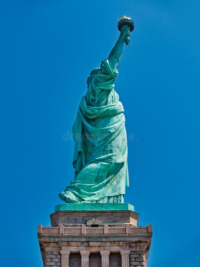 Statue of liberty side view against clear blue sky. Statue of liberty side view against clear blue sky