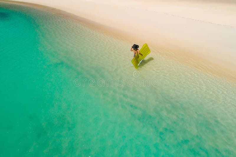 Aerial drone aerial view of Beautiful girl having fun on the sunny tropical beach. Seychelles. Aerial drone aerial view of Beautiful girl having fun on the sunny tropical beach. Seychelles.