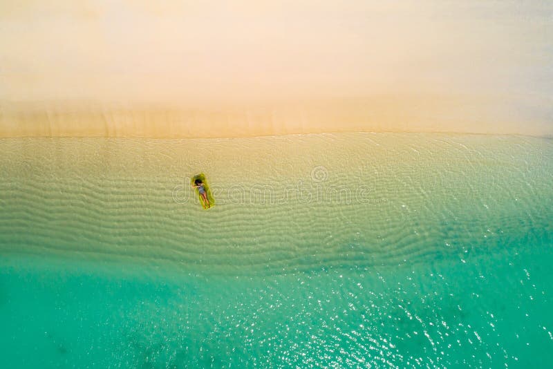 Aerial drone aerial view of Beautiful girl having fun on the sunny tropical beach. Seychelles. Aerial drone aerial view of Beautiful girl having fun on the sunny tropical beach. Seychelles.