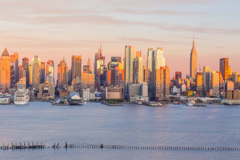 Opinión del panorama del horizonte de la puesta del sol de New York City Midtown Manhattan sobre Hudson River fotografía de archivo libre de regalías Opinión del panorama del horizonte de la puesta del sol de New York City Midtown Manhattan sobre Hudson River fotografía de archivo libre de regalías
