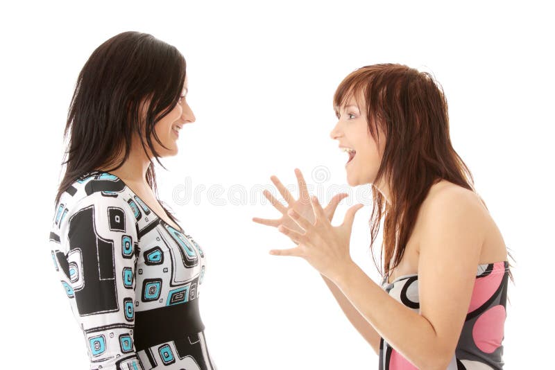 Two young womans talking isolated on white background. Two young womans talking isolated on white background