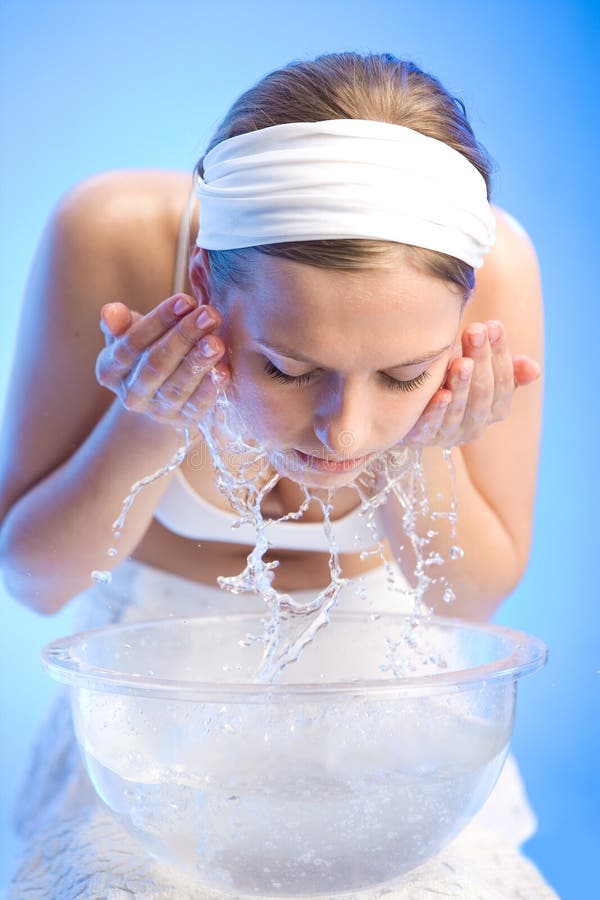 Young beautiful girl is washing her face. Young beautiful girl is washing her face