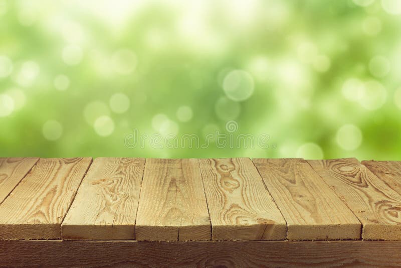 Opróżnia drewnianego pokładu stół z ulistnienia bokeh tłem Przygotowywający dla produktu pokazu montażu