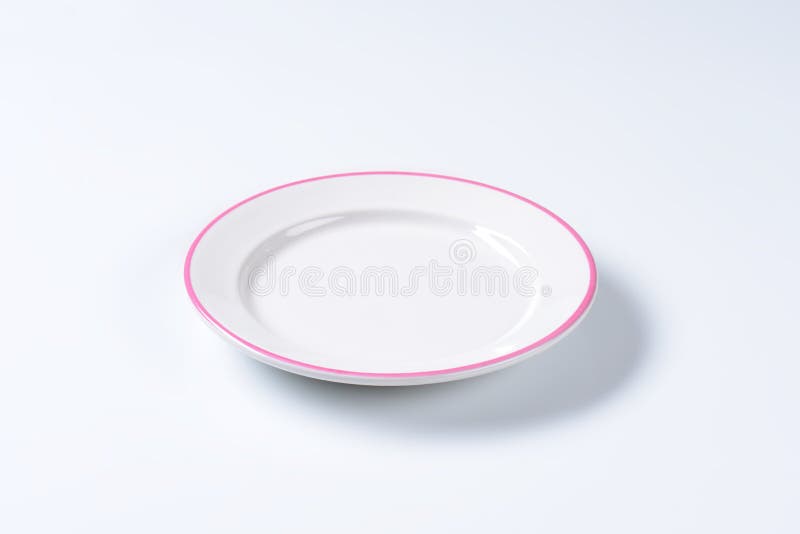Rimmed dinner plate with pink colored edge. Rimmed dinner plate with pink colored edge