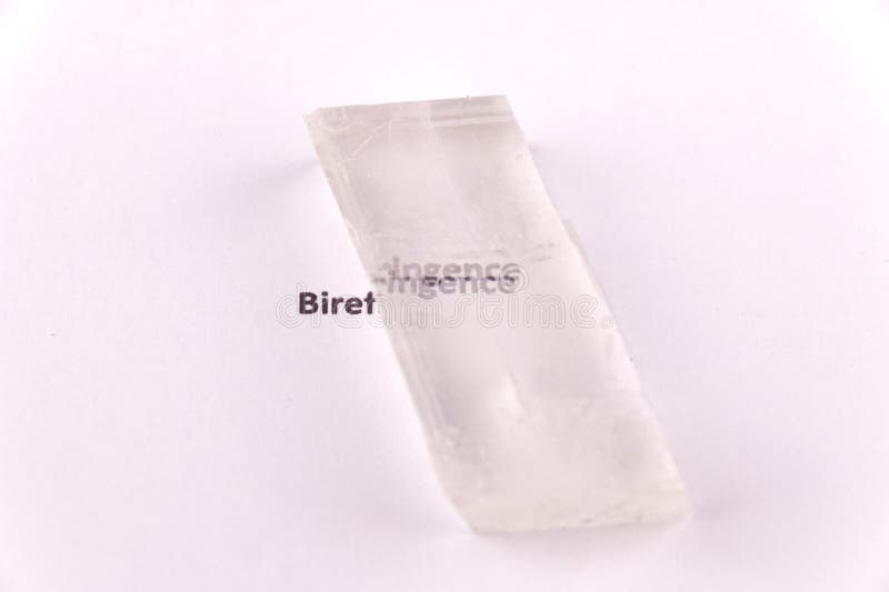 Optical birefringence demonstrated using a text using a natural double spar calcite crystal stock photos