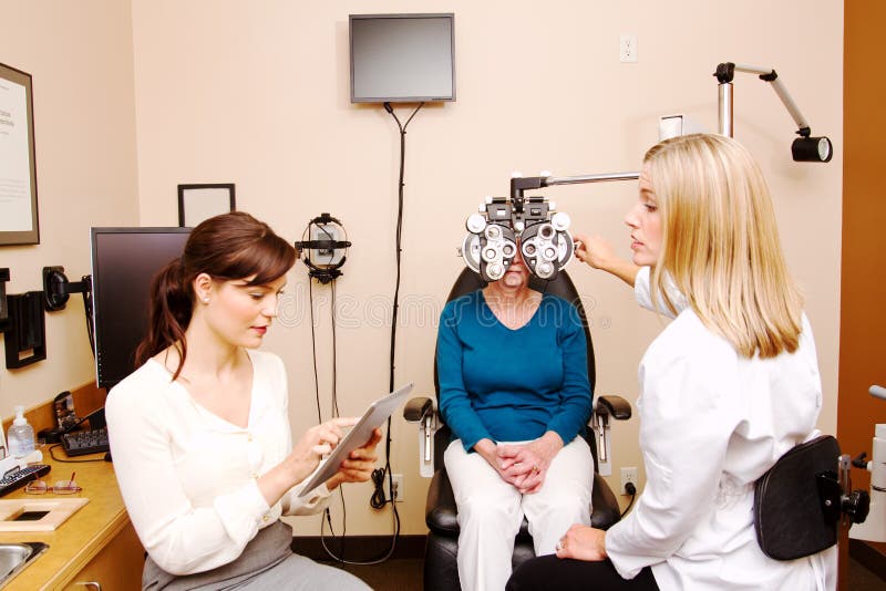 Optician checking with employee for needed info royalty free stock photos