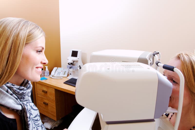 Optician preparing client for tonometer test royalty free stock images