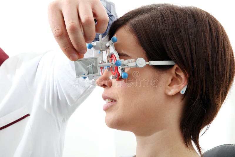 Optician with trial frame, optometrist doctor examines eyesight