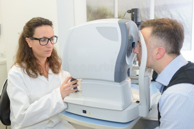 Optometrist Does Eye Exam on Patient Stock Photo Image of black