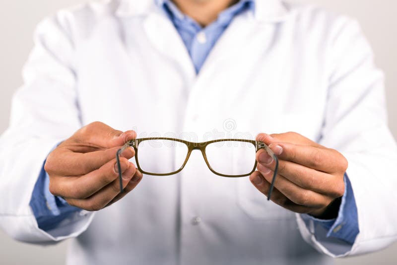 Optometrist Giving New Eyeglasses To Patient Stock Photo Image of