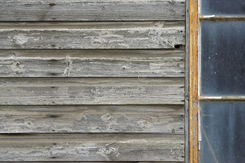 Detail of an abandoned wooden outbuilding with dirty windows. Detail of an abandoned wooden outbuilding with dirty windows.