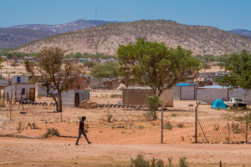 A man walking in the desert village, with shacks and hills in the background royalty free stock photos A man walking in the desert village, with shacks and hills in the background royalty free stock photos