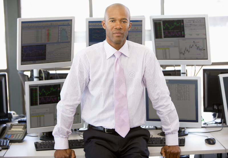 Portrait Of Stock Trader In Front Of Computer Monitors. Portrait Of Stock Trader In Front Of Computer Monitors