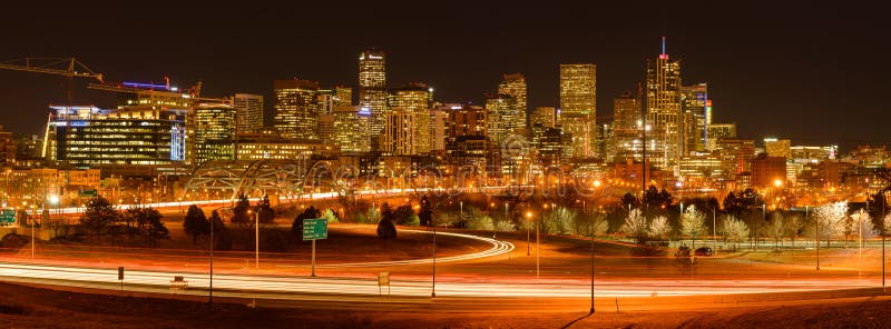 Denver, Colorado, USA - December 09, 2015: A panoramic view of evening rush-hour at west-side of Downtown Denver, with its glittering skyscrapers and busy highway and streets. Denver, Colorado, USA - December 09, 2015: A panoramic view of evening rush-hour at west-side of Downtown Denver, with its glittering skyscrapers and busy highway and streets.