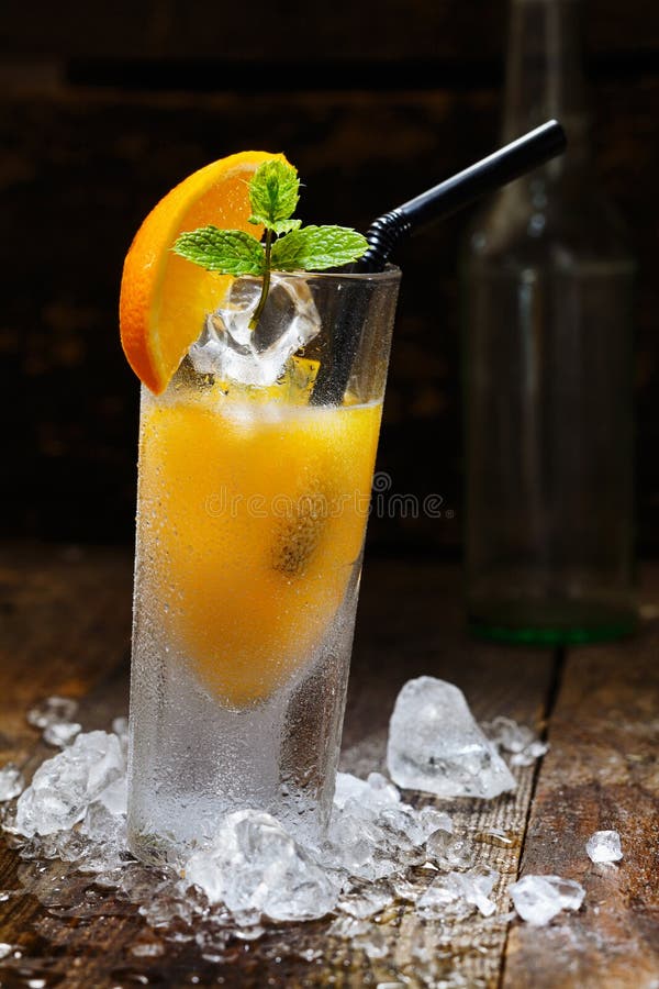 Cool Orange Alcohol Drink with crushed Ice on wooden table for drink concepts