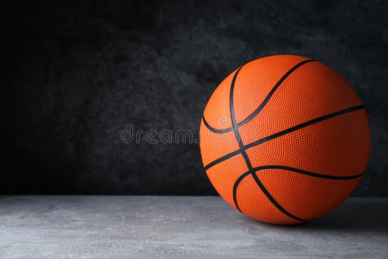 Orange Ball on Light Grey Table, Space for Text. Basketball Equipment
