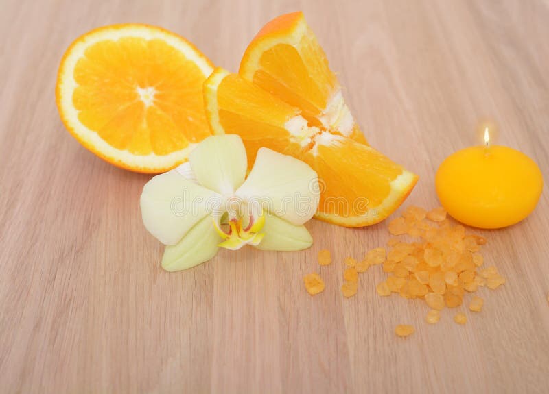 Orange bath salt orchid flower and candle on wooden background stock images Orange bath salt orchid flower and candle on wooden background stock images