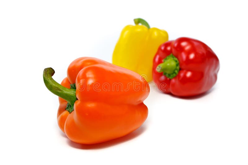 Dark orange bell pepper with red and yellow peppers in the backgournd