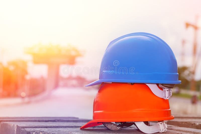 Orange and blue safety helmet in construction side. royalty free stock photo