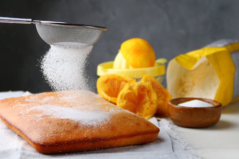 Orange Cake Decorating Sugar Powdered and Ingredients on Background