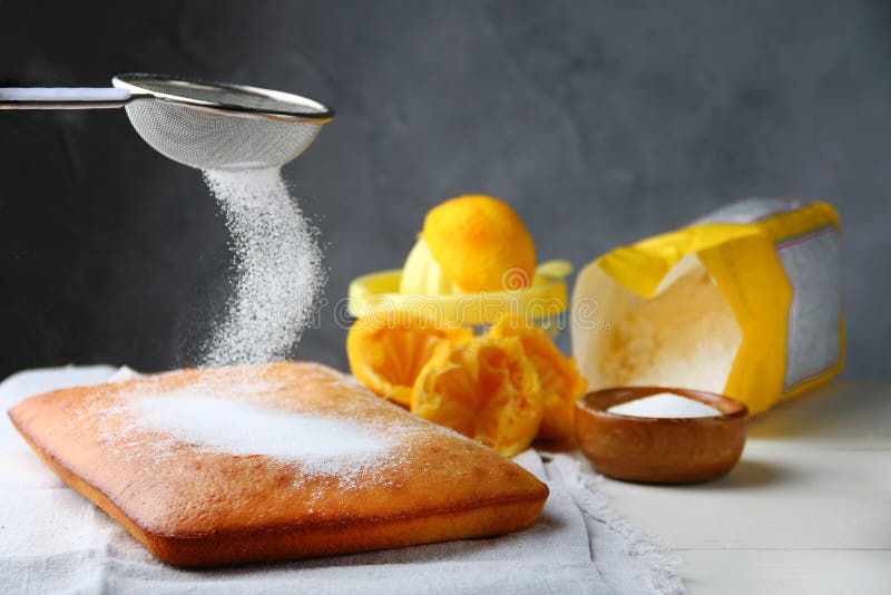 Orange Cake Decorating Sugar Powdered and Ingredients on Background
