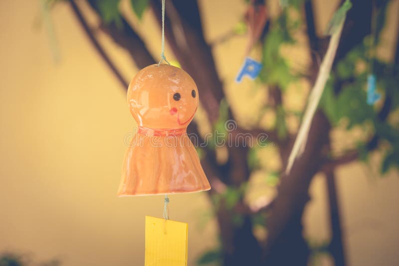 Orange chasing rain Japanese doll hanging on branches tree. royalty free stock image Orange chasing rain Japanese doll hanging on branches tree. royalty free stock image