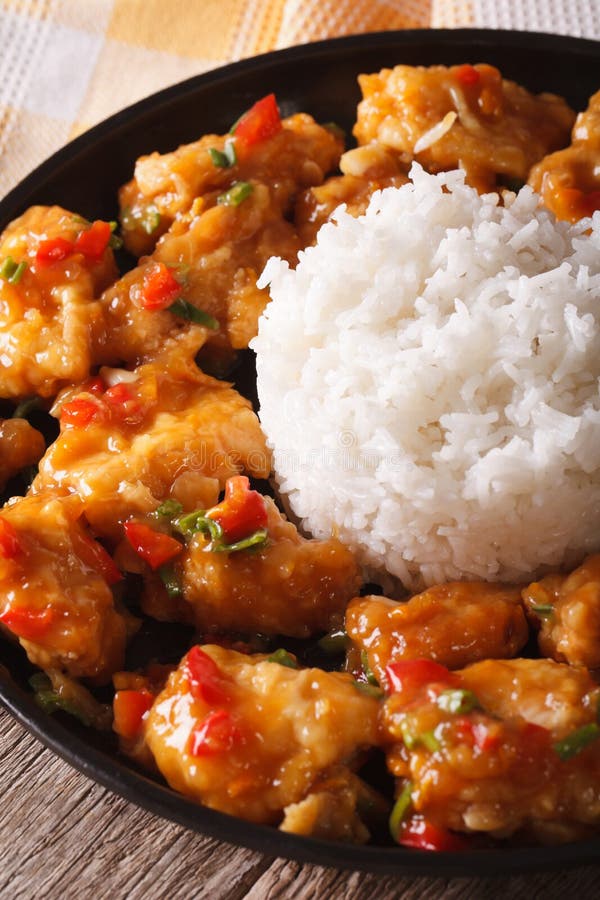 Orange Chicken with Rice Garnish Close Up on a Plate. Horizontal Stock