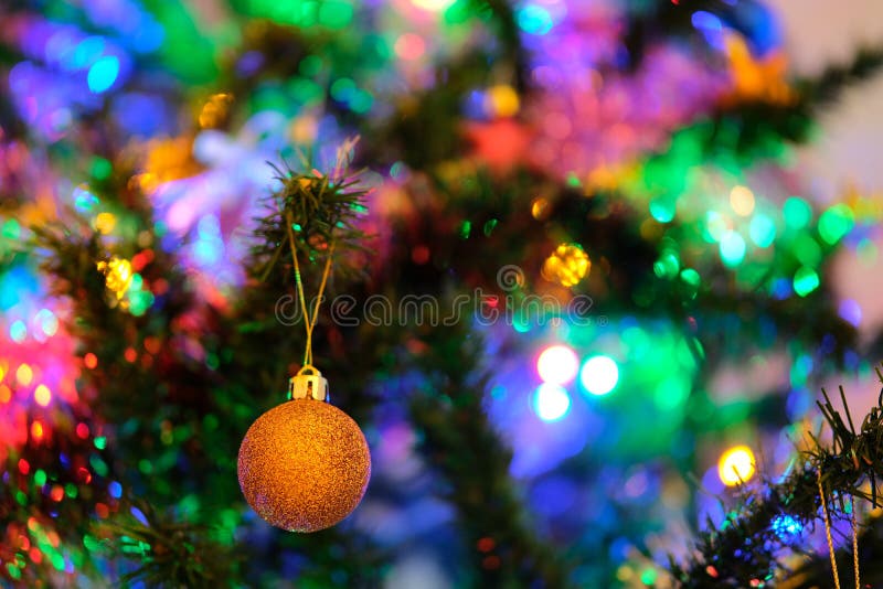 Orange Christmas ball ornament on a Christmas tree with nice blurry background royalty free stock photo Orange Christmas ball ornament on a Christmas tree with nice blurry background royalty free stock photo